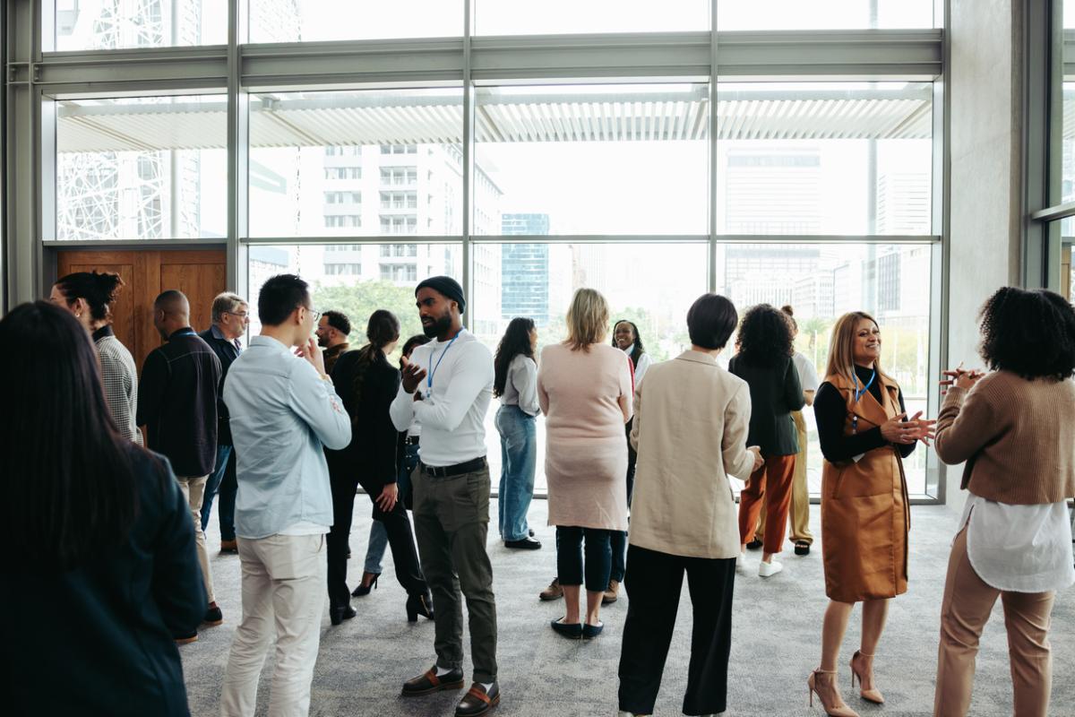 Corporate crowd engaging in teamwork during business event